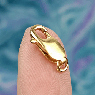 gold clasp on finger