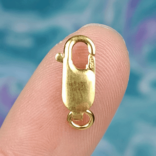 gold clasp on finger