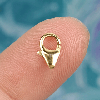 gold clasp on finger