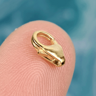 gold clasp on finger