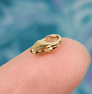 gold clasp on finger