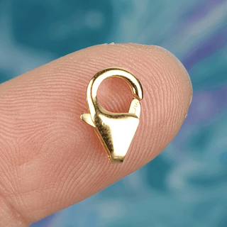 gold clasp on finger