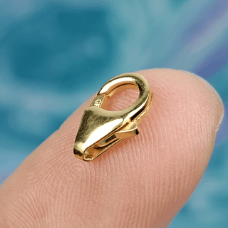 gold clasp on finger