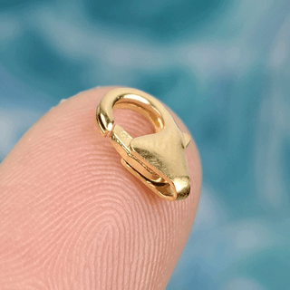gold clasp on finger