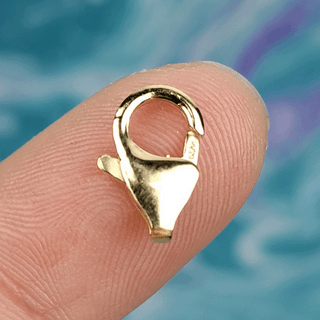 gold clasp on finger