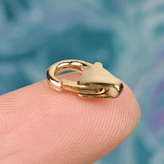 gold clasp on finger