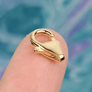 gold clasp on finger