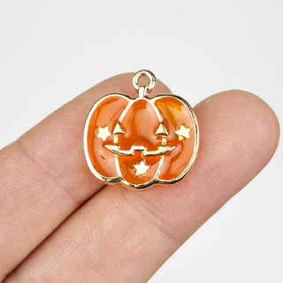 Jack O Lantern Charm Enamel Orange Transparent with Gold on a person's fingers