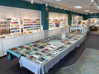 Bead Store Interior layout of Let's Bead! with many beads for sale hanging on walls and displayed on tables