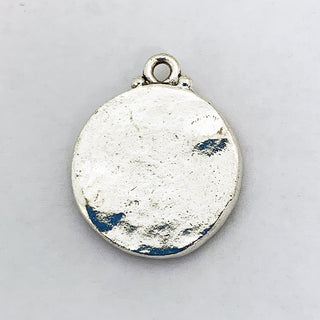 Hammared back of a  silver plated  round charm.