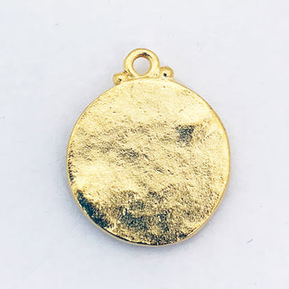 Hammered back of a round satin gold plated charm.