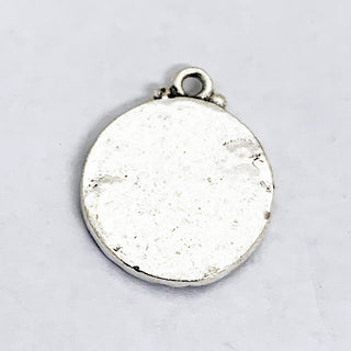 Back of round antique silver plate charm.