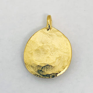 Back of a  gold plated hammered teardrop charm.