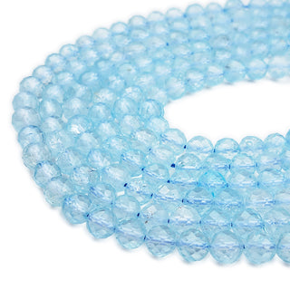 Strands of 7mm round faceted Topaz beads.