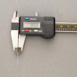 Stretch Magic Elastic Cord in a digital caliper showing .5mm size