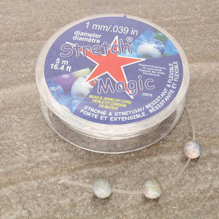 Stretch Magic Elastic Cord size 1mm with beads on a textured surface