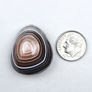 botswana agate pendant next to a dime for size reference