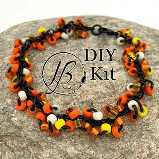 orange yellow and black shaggy bracelet on a rock