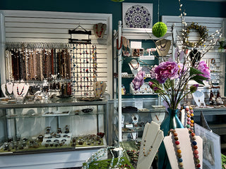 Inside store with bead strand, kits, and fair trade gifts on display.
