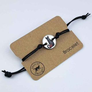 Black Cat with Heart design black leather bracelet on a brown paper jewelry card on a white background