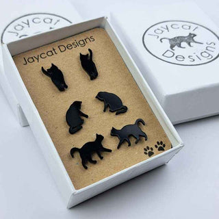 three pairs of black cat stud earrings in a gift box on a white background
