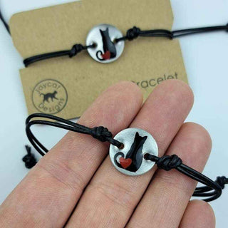 Black Cat with Heart design black leather bracelet on a person's hand