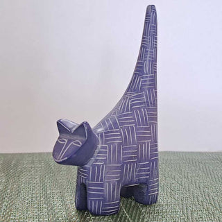 Blue/Purple ceramic cat figurine with geometric pattern on a textured surface