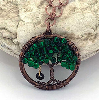 A necklace kit with a green pendant shaped like a tree