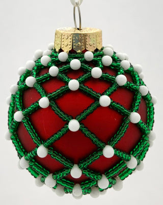 Beaded ornament with red bulb and green and white beads.
